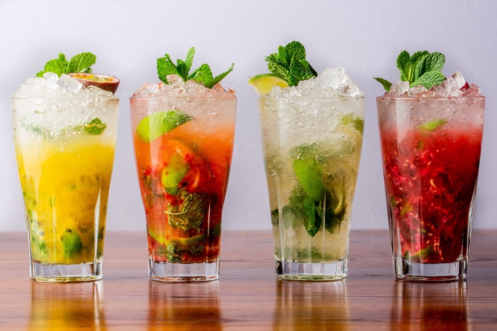 a,variety,of,mojitos,in,a,row,on,wooden,table